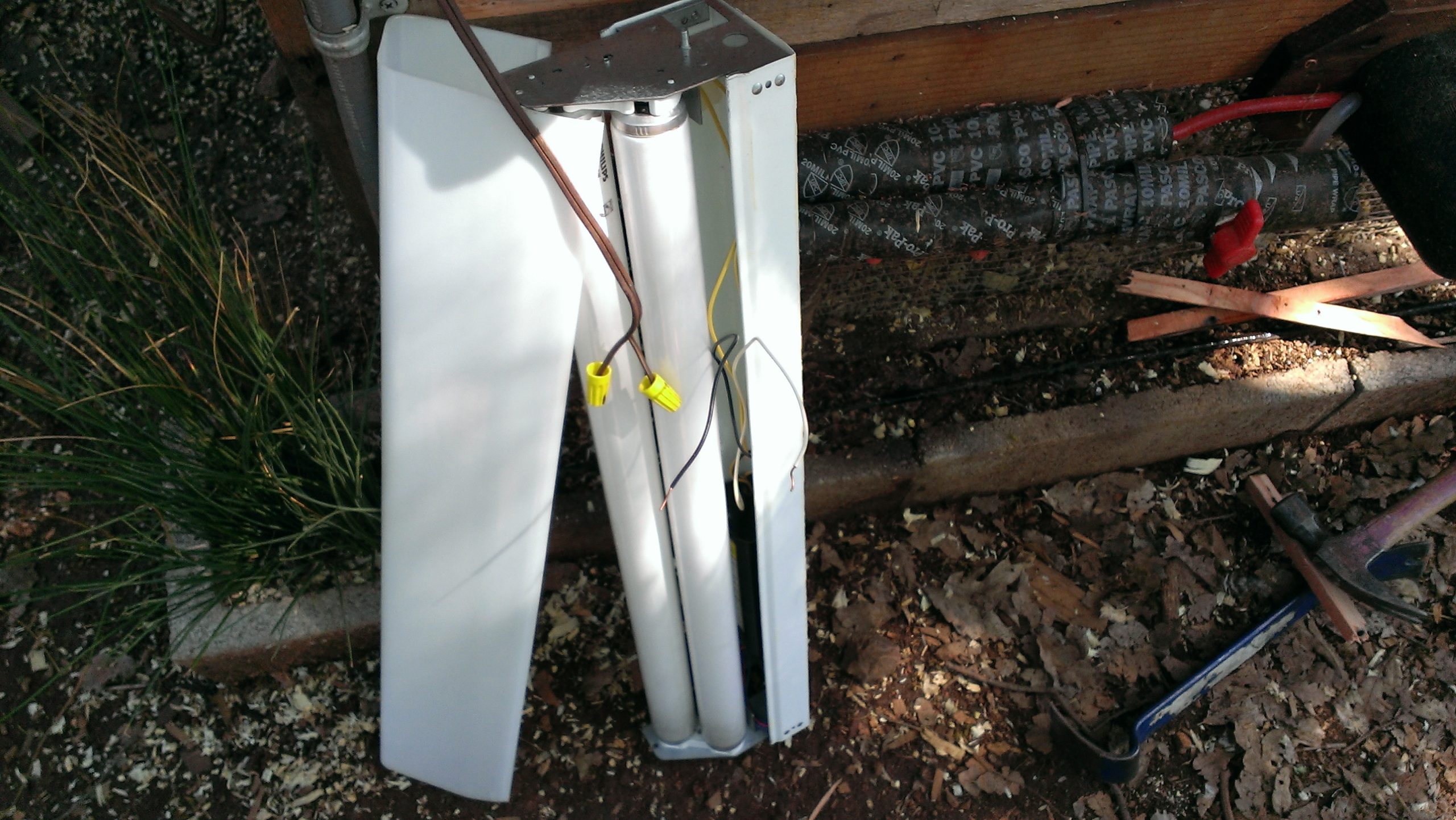 Wiring Chicken Coop Heater (shop light with cover off) - Construction Exterior Pipe Protection (mounted under stairs and above wrapped pipe)