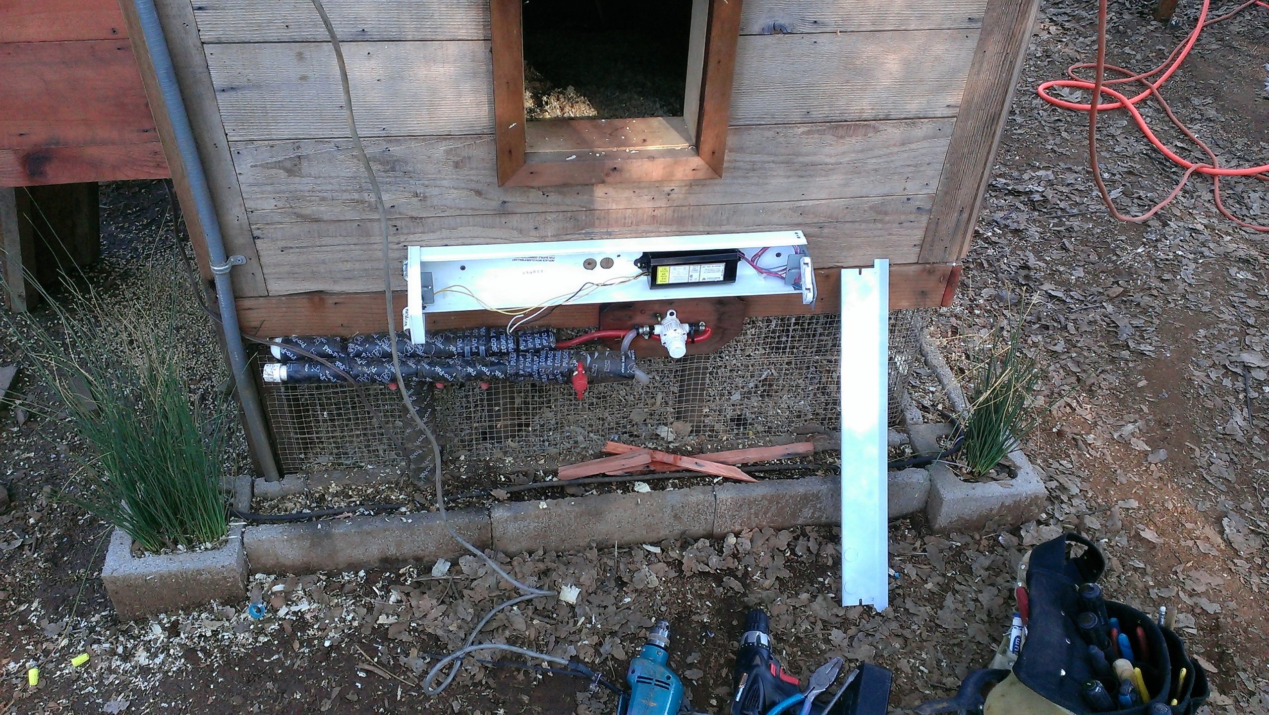 Wiring Chicken Coop Heater (shop light with cover off) - Exterior Pipe Protection (mounted under stairs and above wrapped pipe)