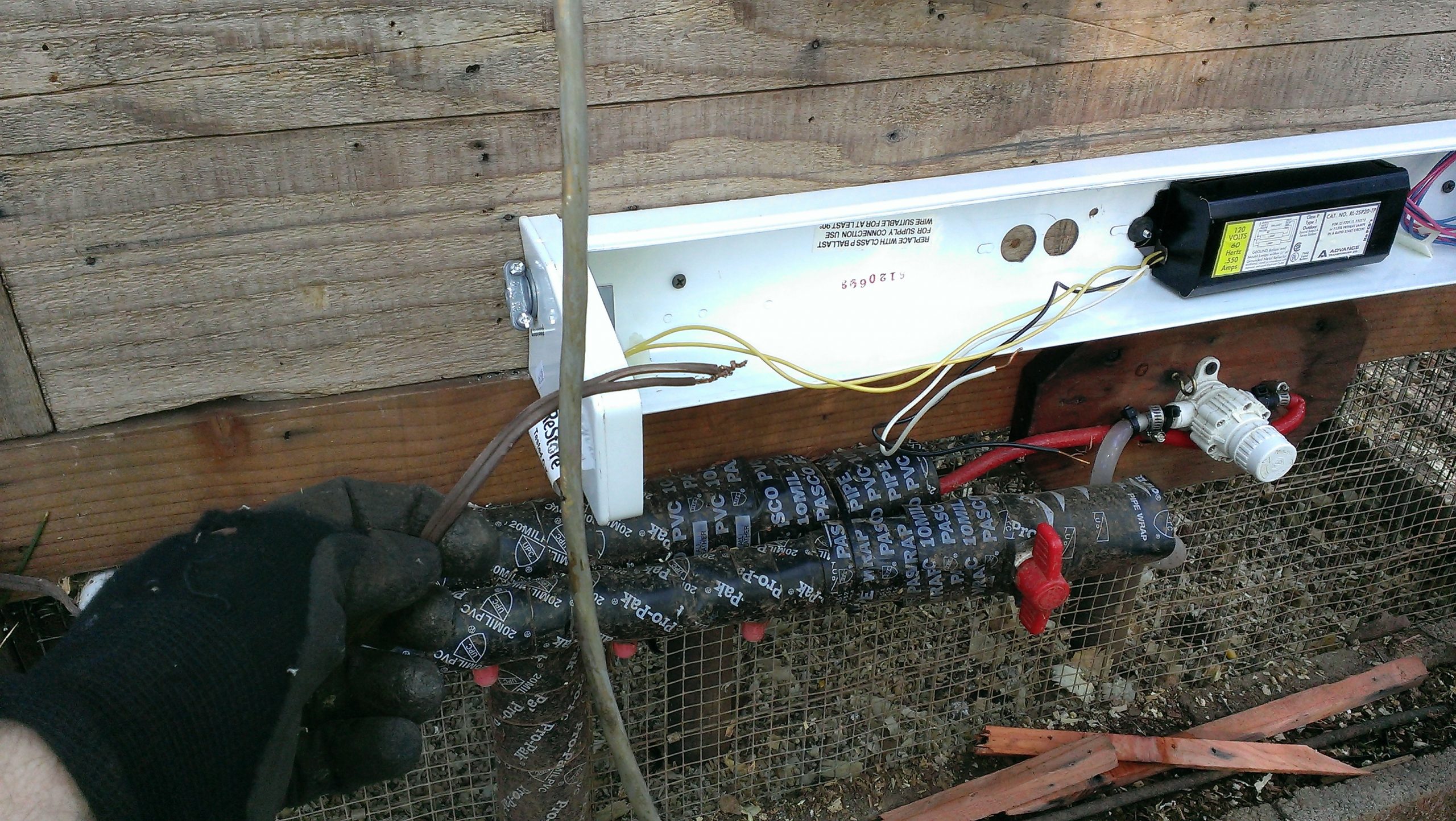 Wiring Chicken Coop Heater (shop light with cover off) - Exterior Pipe Protection (mounted under stairs and above wrapped pipe)